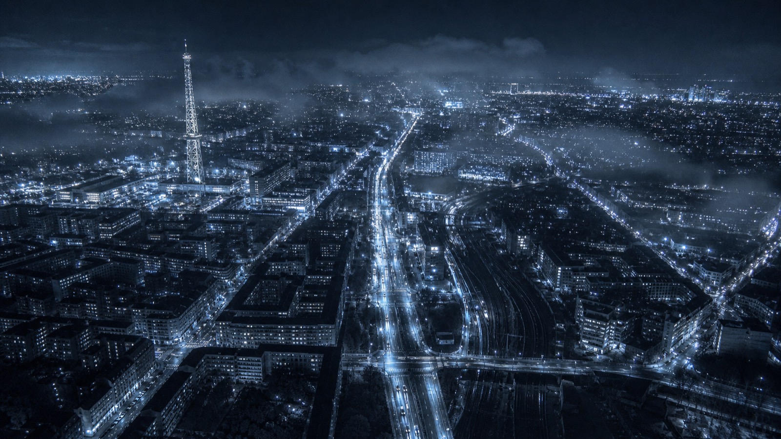 Berlin from the air at night, an arterial road cutting through the city.